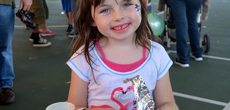 Six-year-old Sam Robbins smiles for a free hot dog.