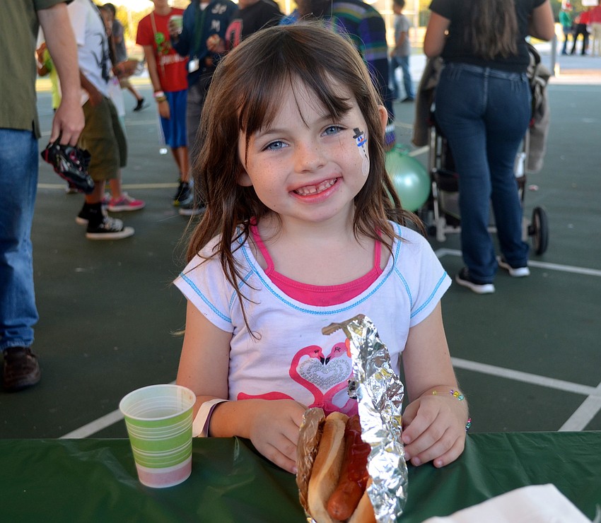 Six-year-old Sam Robbins smiles for a free hot dog.