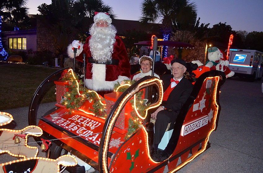 John and Millie Emond, as Mr. and Mrs. Claus, and Bill Crocker play dress up for their neighbors.