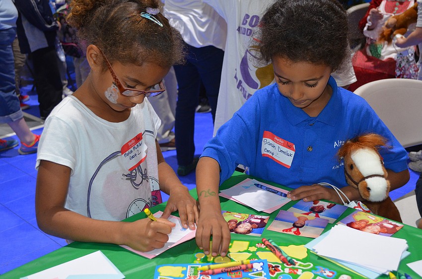 Mariah McMiller and Sarah Demlak decorate cards.