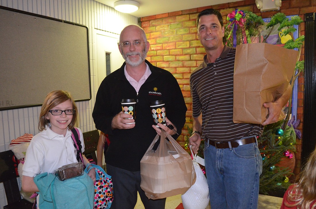 Colin and Siobhan Boyle, with the help of volunteer Rob Wenzel,  take home a turkey and meal.