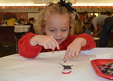 Molly Harris works hard on her snowman ornament.