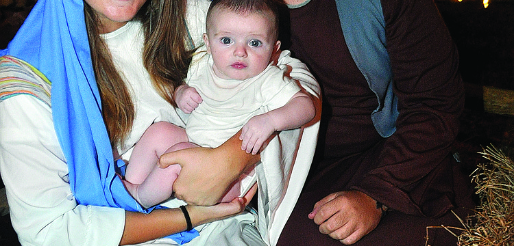 Meghan Neu, Ryan Hitchcock, 3 months, and Danny Riordan play Mary, baby Jesus and Joseph at Living Lord Lutheranâ€™s Church annual "Night in Bethlehem" event Dec. 7.