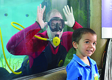 Nathan Alderman smiles with a diver in the background at Mote Marine's World Oceans Day Family Festival June 8. 6