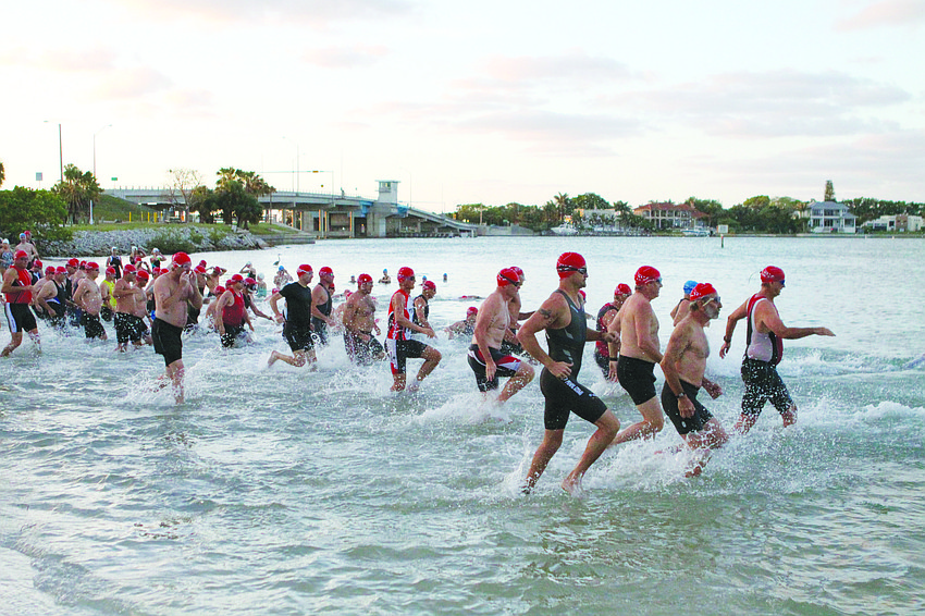 Athletes dash into the water at the second Longboat Key Spring Triathlon in May.