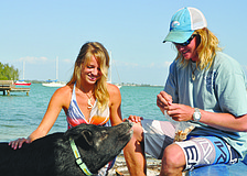 Miniature potbellied pig Bacon, with owners Molly Lefevre and Lance Plowman, escaped from a fire in February on Gulfside Road by squeezing himself â€” potbelly and all â€” through the small glass panel of a jalousie window.