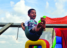 Joshua Zuniger swings as high as he can  during a celebration of the first anniversary of Bayside Community Church's East Sarasota campus Sept. 8.