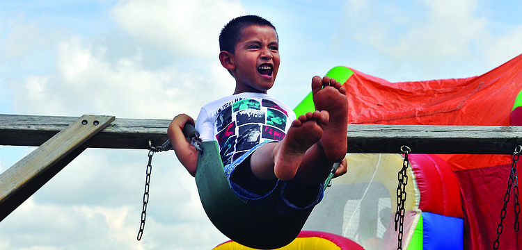 Joshua Zuniger swings as high as he can  during a celebration of the first anniversary of Bayside Community Church's East Sarasota campus Sept. 8.