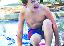 Jack Baty keeps his balance during a water game of Twister at Chabad of Bradenton & Lakewood Ranch's Camp Gan Israel July 8.