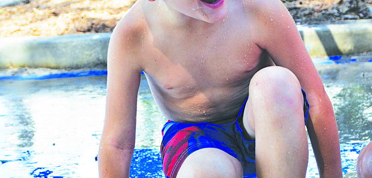 Jack Baty keeps his balance during a water game of Twister at Chabad of Bradenton & Lakewood Ranch's Camp Gan Israel July 8.