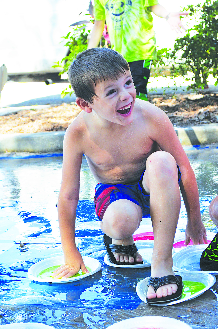 Jack Baty keeps his balance during a water game of Twister at Chabad of Bradenton & Lakewood Ranch's Camp Gan Israel July 8.