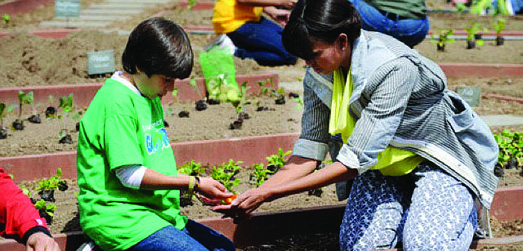 Emilio Vega, an 11-year-old Gullett Elementary School student from Colombia, was one of two students chosen to work side-by-side with first lady Michelle Obama as she planted a garden at the White House April 4.