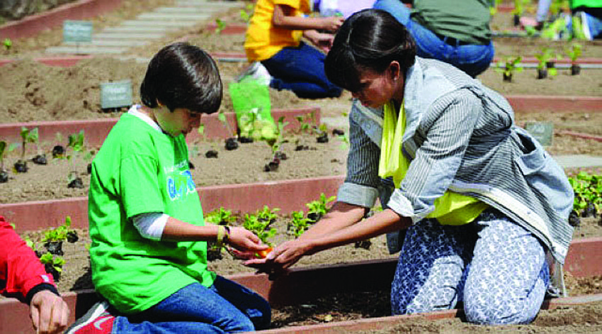 Emilio Vega, an 11-year-old Gullett Elementary School student from Colombia, was one of two students chosen to work side-by-side with first lady Michelle Obama as she planted a garden at the White House April 4.