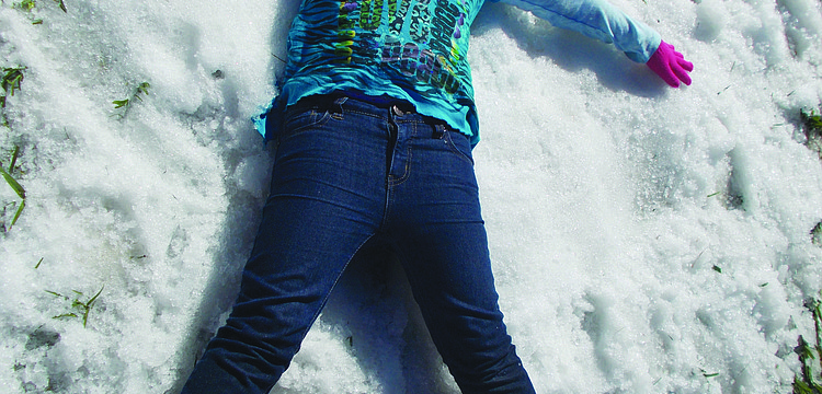 Foundations Academies' Lorrin Mumford makes a snow angel during the school's Winter Wonderland event Jan. 25.
