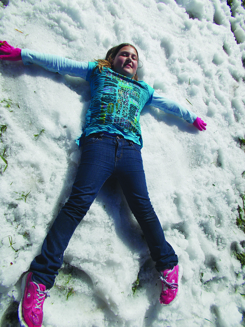 Foundations Academies' Lorrin Mumford makes a snow angel during the school's Winter Wonderland event Jan. 25.