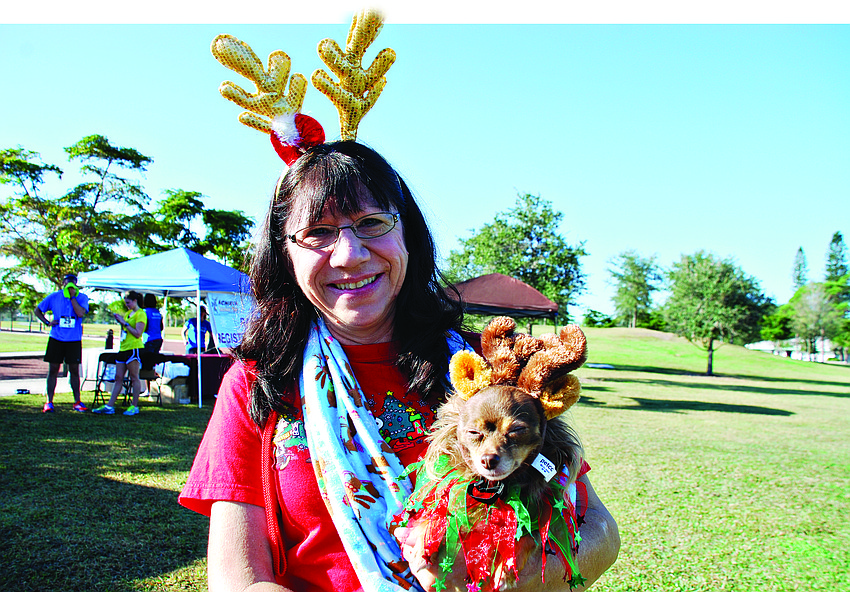 Chris Deluna with her dog, Kiwi, at the third annual Achieva Reindeer Trot Dec. 7, at Payne Park.