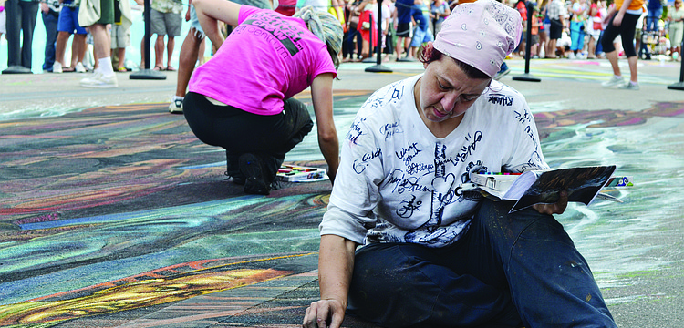 Artist Ketty Grossi works on her chalk art during the 2013 "Legacy of Valor"-themed Sarasota Chalk Festival, which took place Nov. 13 through Nov. 18.
