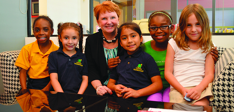 Incoming Girls Inc. Executive Director Robin Rose sits with several of the Girls Inc. girls in April. Rose joined Girls Inc. in August.