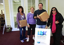 Victoria Jacobson, Gail Loefgren, Rick Bergere and Yvonne Schloss prepare for a day filled with tools and moving boxes as they work to create a welcoming chamber office.