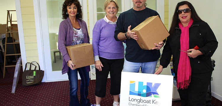 Victoria Jacobson, Gail Loefgren, Rick Bergere and Yvonne Schloss prepare for a day filled with tools and moving boxes as they work to create a welcoming chamber office.