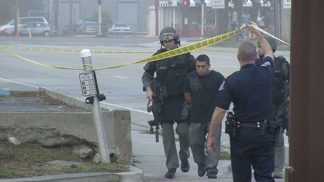 SWAT officers arrest the suspect of an armed sexual battery before 8:30 a.m. Monday.