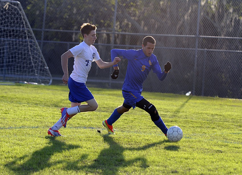 Sarasota Christianâ€™s Lane Chupp looks to maintain possession away from Eagles forward Brendon Durmody.