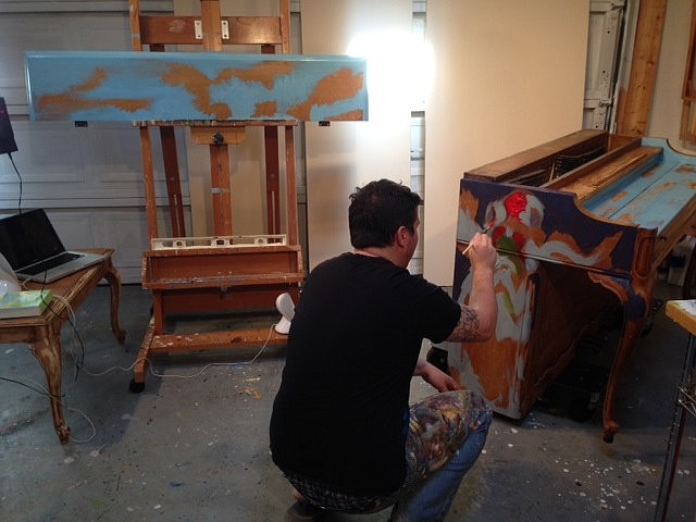 Tim Jaeger, one of six local artists selected to participate in the Sarasota Keys project, works on painting a piano that will be placed downtown Jan. 17.