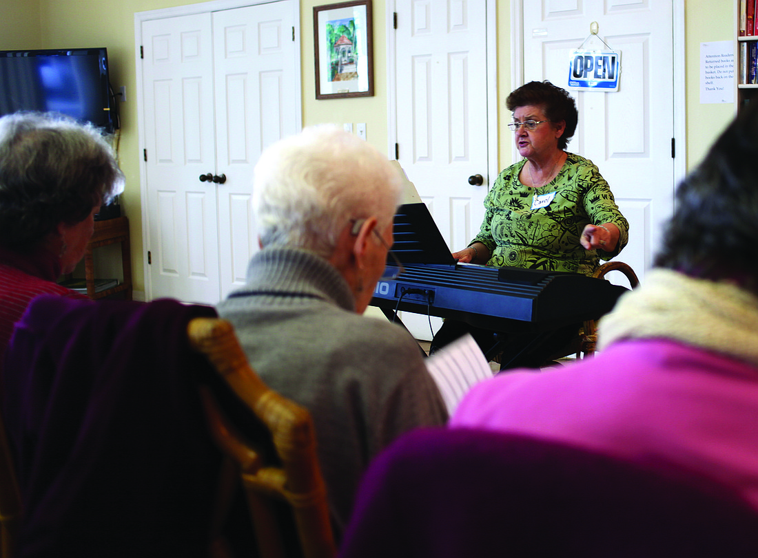 Director Carol Whitfield plays piano and instructs the Key of Sea Chorus during its meeting Tuesday, Jan. 7.