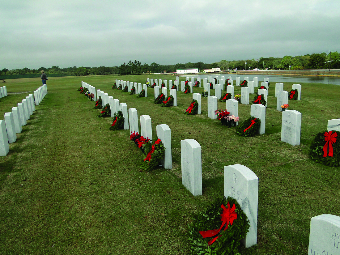 File photo. Volunteers decorated graves of veterans at Sarasota National Cemetery with wreaths in December for the fifth consecutive year. The national Wreaths Across America campaign began in 1992.