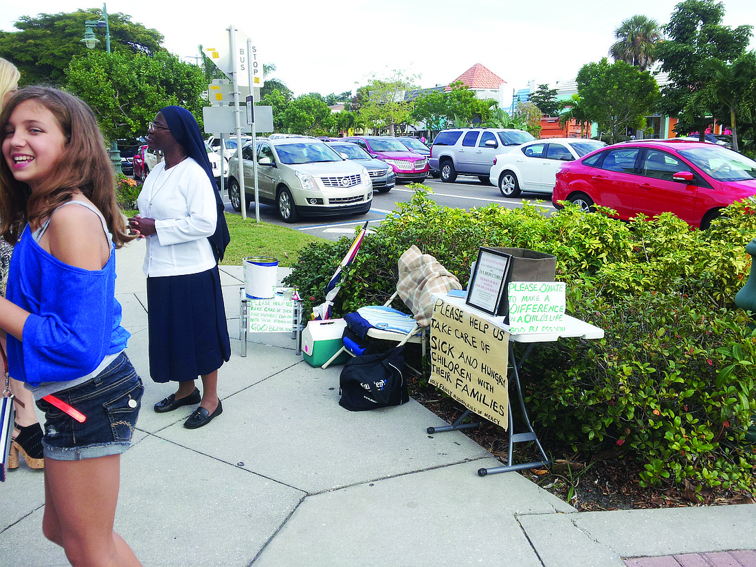 Courtesy photo A woman soliciting donations on St. Armands Circle is upsetting merchants and concerns BID members.