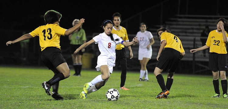 Cardinal Mooney senior defender Jasmine Rosales controls the ball around a host of Booker midfielders.