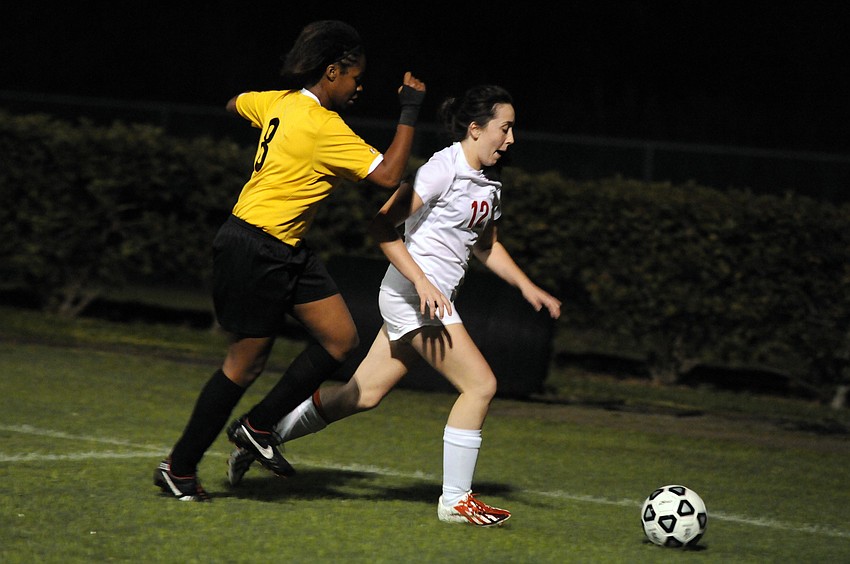 Booker Highâ€™s Sharae Castillano and Cardinal Mooneyâ€™s Farrah Nelson race toward the ball before it lands out of play.