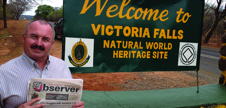 NATURAL FIT. Longboat Key resident Ernie Goffi caught up on his Sarasota Observer news while on a trip to Victoria Falls, Zimbabwe.