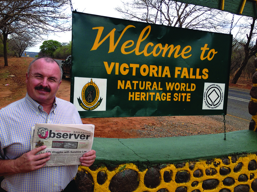 NATURAL FIT. Longboat Key resident Ernie Goffi caught up on his Sarasota Observer news while on a trip to Victoria Falls, Zimbabwe.