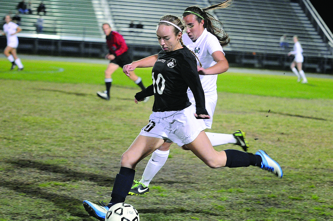 Photos by Jen Blanco Braden River's Liz Shirey pushes the ball up the field in the first half.