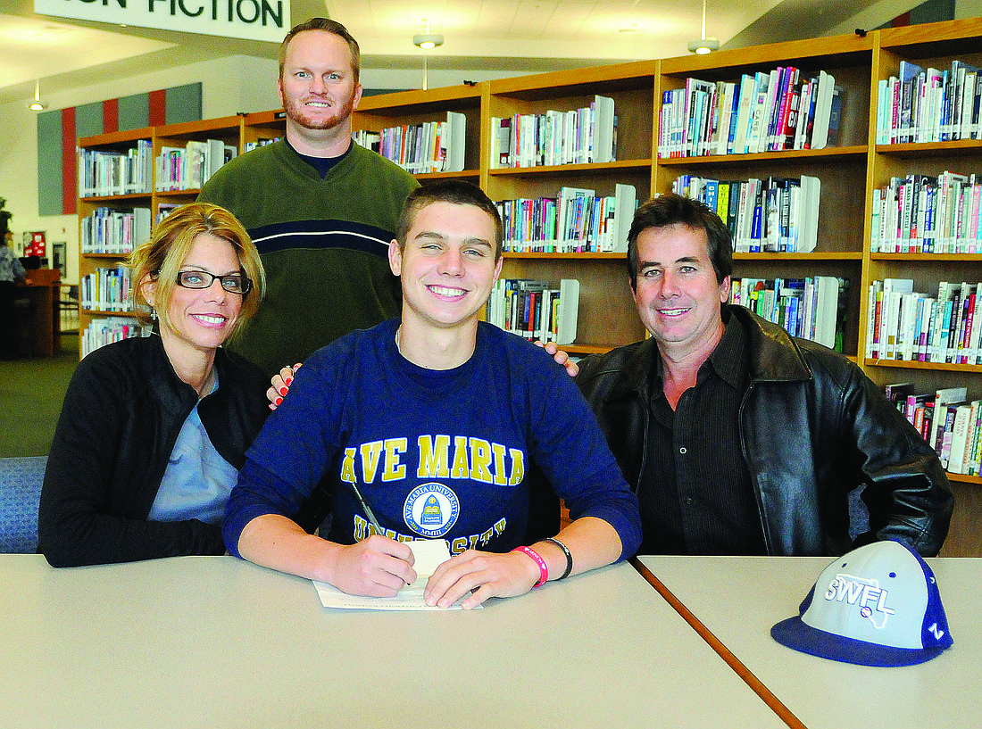 Jen Blanco Lakewood Ranch High catcher Andrew Giddens, pictured with his parents Helaine and Randy Giddens and Lakewood coach Ryan Kennedy, behind, chose Ave Maria University over the University of North Florida.