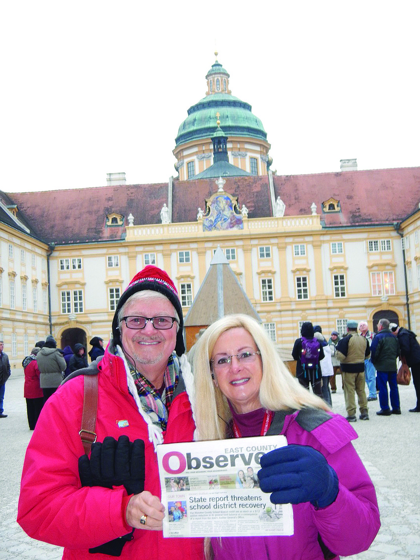 RIVER RENDEZVOUS. East County residents Chic and Robin Hansen read their East County Observer in front of the Melk Abbey along the Danube River in Austria. The couple enjoyed a riverboat cruise from Nuremberg, Germany, to Vienna.