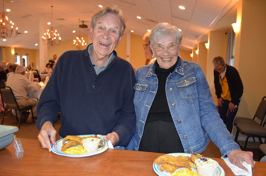 Doug Finfrock and Marsha Rhoades pick up their plates.