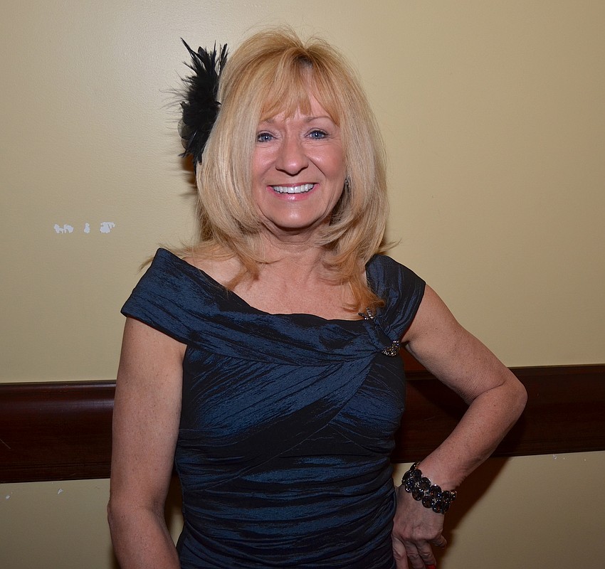 Carol Busse chats with friends before dinner.