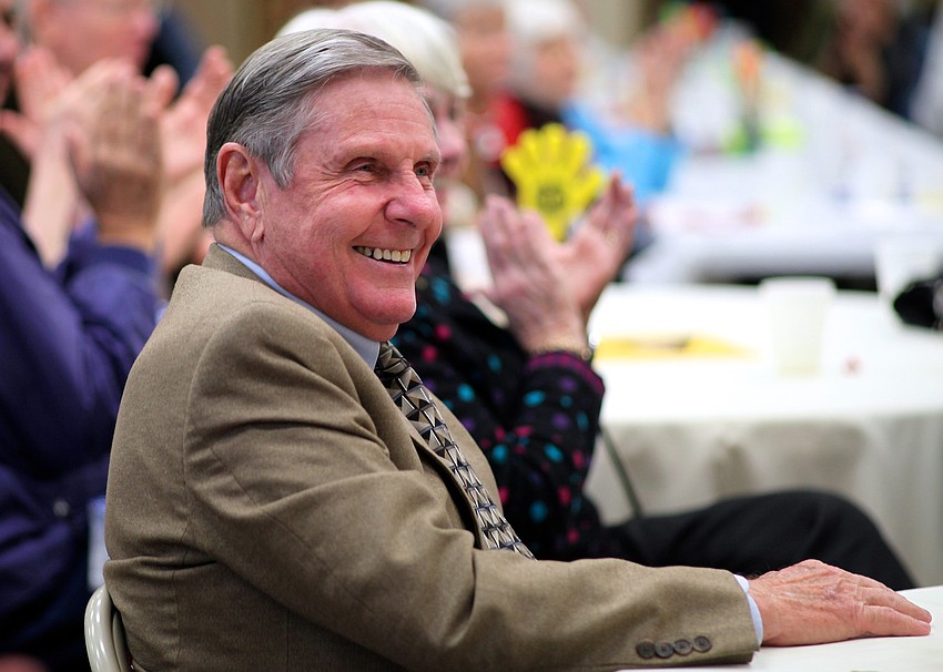 The Rev. Bruce Porter laughs as parishioners share memories and stories during the eveningâ€™s program.