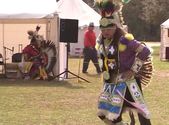 Leland Thompson performs a pow wow dance imitating the movements of the prairie chicken at the Sarasota Native American Indian Festival.