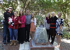 Austin Warner, Jackson Warner, Lindsey Warner, Jan Marsh, David Marsh, Kristin Marsh, Kailey Marsh, Claire Marsh and Kara Marsh stand with the new Jim Marsh memorial statue.