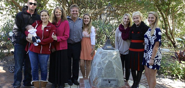 Austin Warner, Jackson Warner, Lindsey Warner, Jan Marsh, David Marsh, Kristin Marsh, Kailey Marsh, Claire Marsh and Kara Marsh stand with the new Jim Marsh memorial statue.