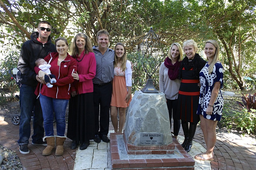 Austin Warner, Jackson Warner, Lindsey Warner, Jan Marsh, David Marsh, Kristin Marsh, Kailey Marsh, Claire Marsh and Kara Marsh stand with the new Jim Marsh memorial statue.