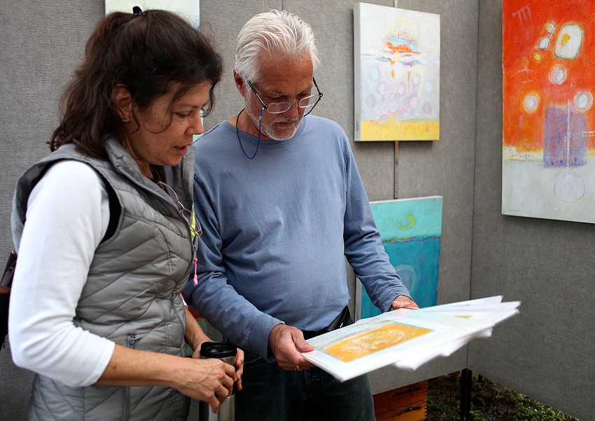 Kyra Strachov discusses her acrylic paintings on canvas with friend Bob Hammond.