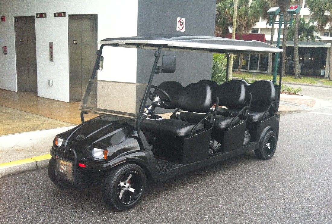 A proposed downtown circulator vehicle, provided by Cruise Car Inc., sits outside of the Palm Avenue parking garage before a trial run tests its battery life.