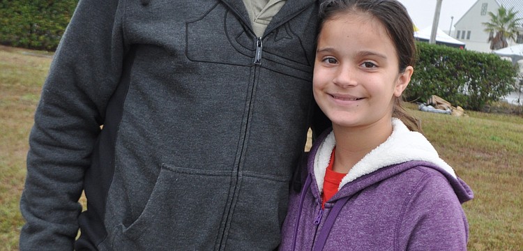 Ken Harpley, with his daughter, Taylor, comes to watch his daughter, Liza, 16, race.