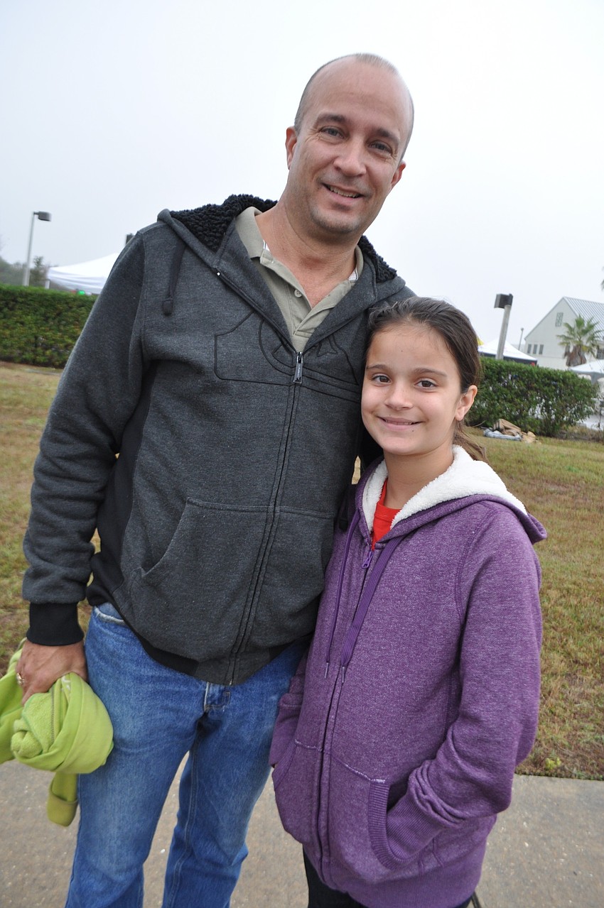 Ken Harpley, with his daughter, Taylor, comes to watch his daughter, Liza, 16, race.