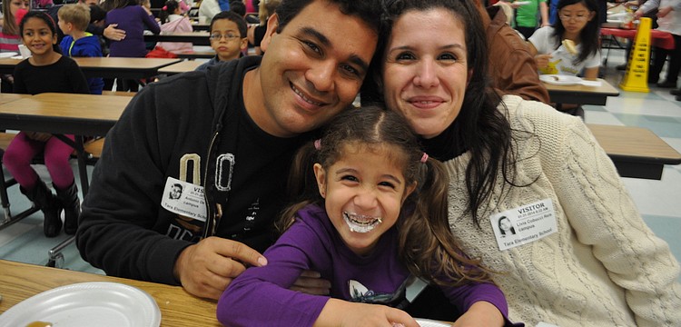 Christopher, Luciana and Matthew Silva prepare to eat.