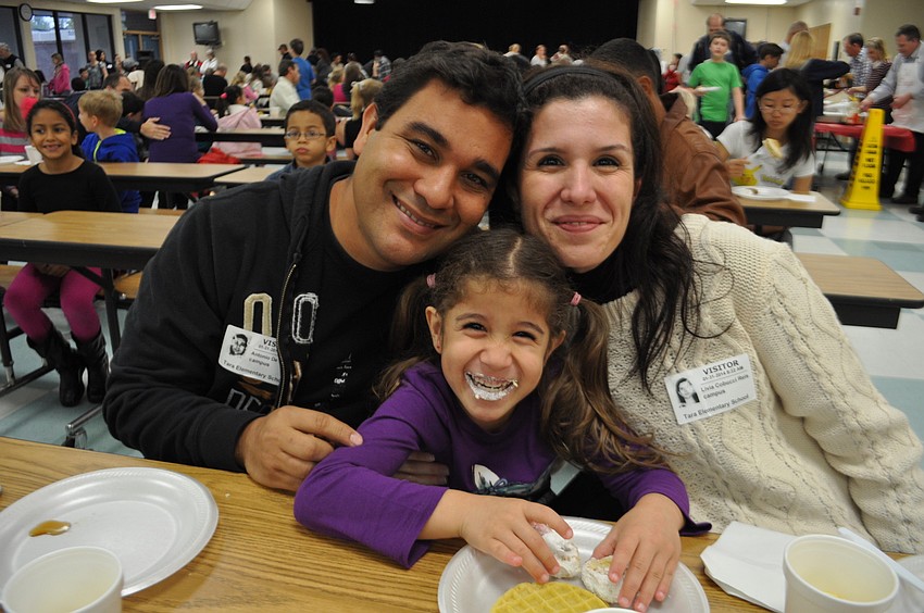 Christopher, Luciana and Matthew Silva prepare to eat.